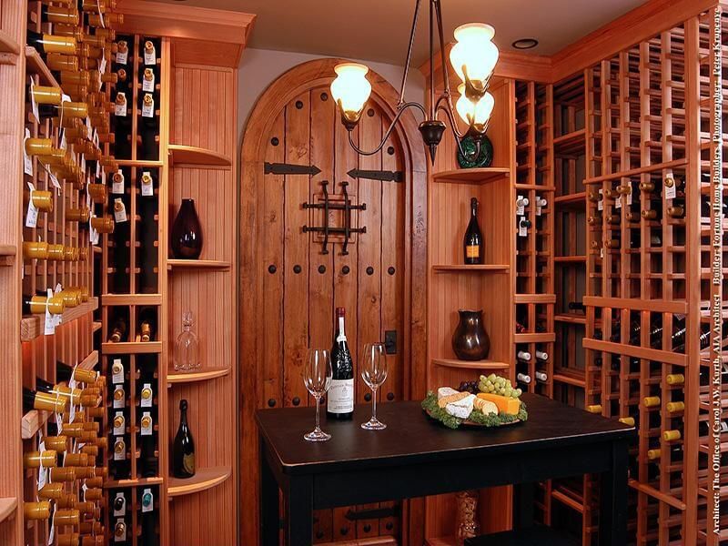 CLWCTT Small wine cellar with tasting table. All wine storing racks made of wood.
