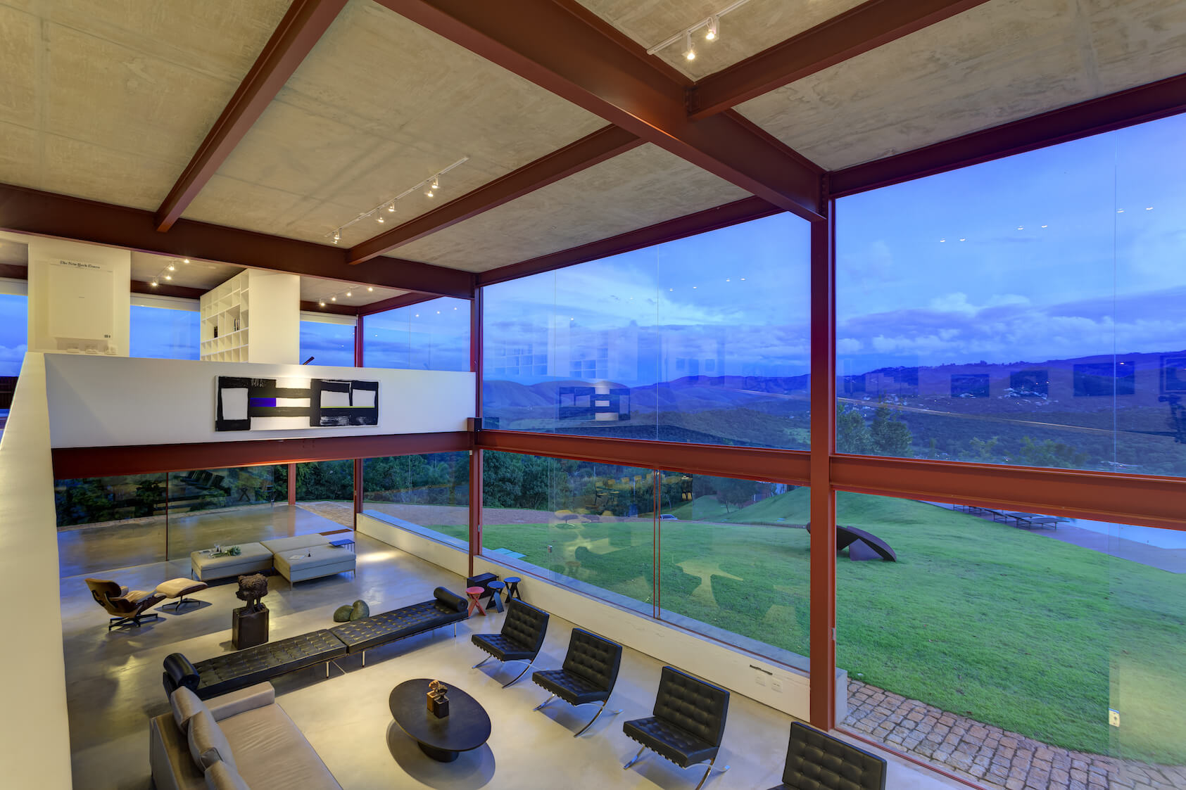From the top of the ramp, we see down onto the array of modern leather seating options and the stone path surrounding the home. From the top of the ramp, we see down onto the array of modern leather seating options and the stone path surrounding the home.