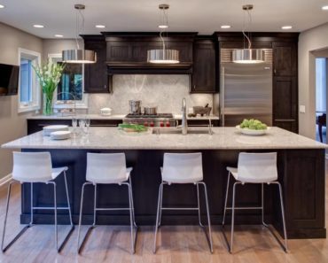 Contemporary kitchen with breakfast bar in small space by Drury Design