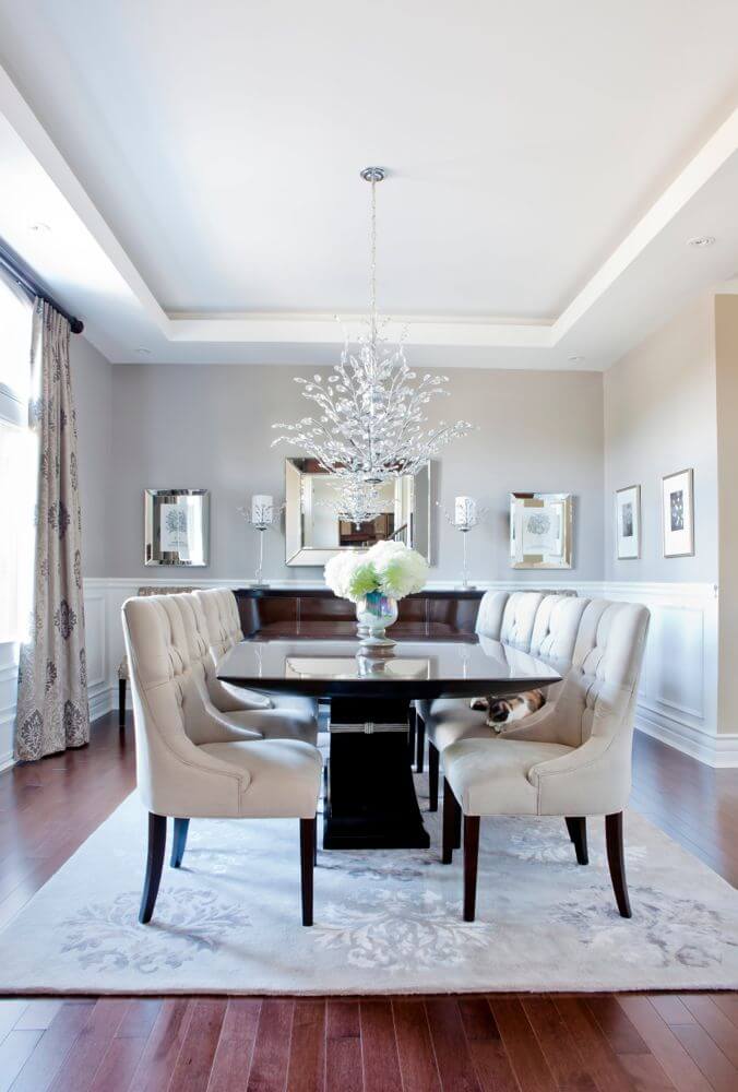 The living room features opulent details circling a black Hudson dining table over the rich hardwood flooring continued from the central living room. The living room features opulent details circling a black Hudson dining table over the rich hardwood flooring continued from the central living room.