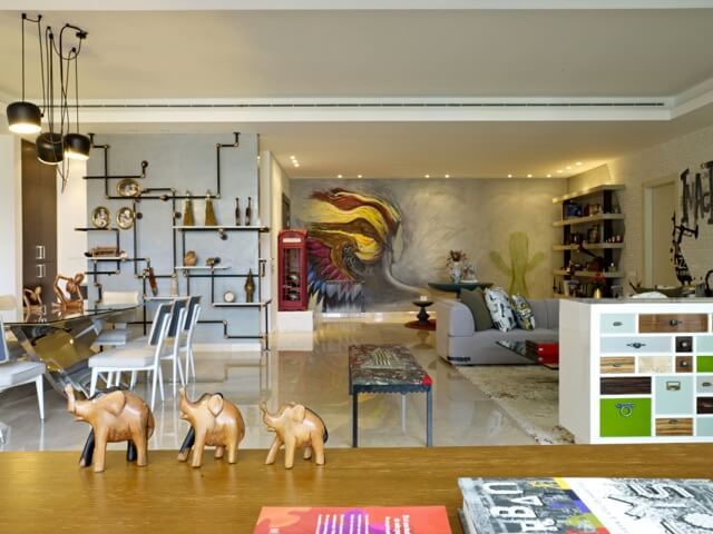Here we see a wide view of the entire open space, with the recycled zinc pipework shelving seen at left, phone booth helmet storage at center, and space-dividing cabinetry unit at right. Here we see a wide view of the entire open space, with the recycled zinc pipework shelving seen at left, phone booth helmet storage at center, and space-dividing cabinetry unit at right.