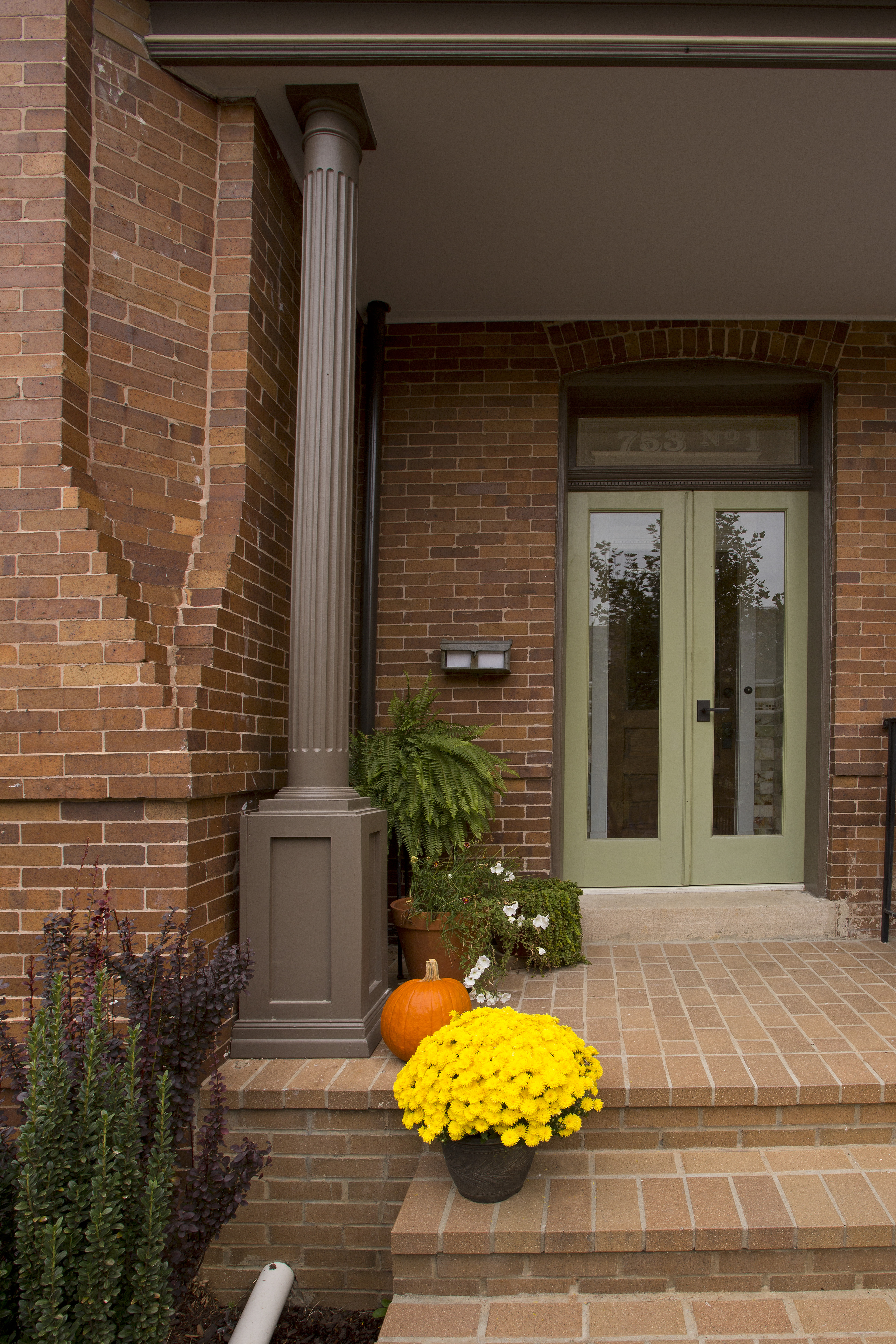 The warm stone steps up to the condos are decorated with bright fall flowers and other plants. The warm stone steps up to the condos are decorated with bright fall flowers and other plants.