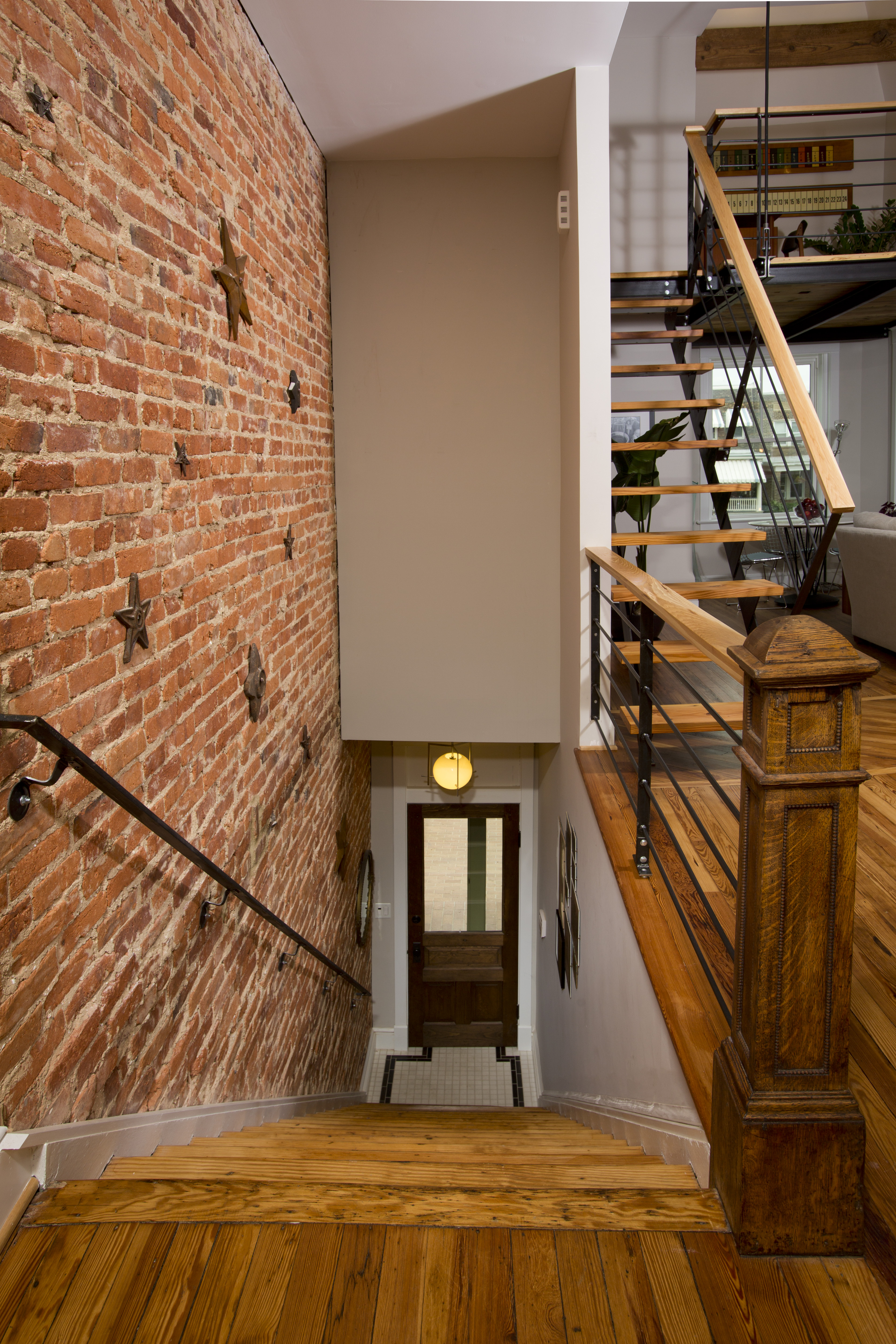 The original pine-heart floors were salvaged, saving both money and original charm. The original brick wall is also exposed on the staircase. The original pine-heart floors were salvaged, saving both money and original charm. The original brick wall is also exposed on the staircase.