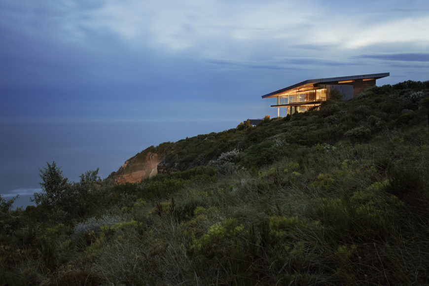 Profile view of the landscape highlights the blended-in nature of the structure, with a roof slant paralleling the slope. Floor to ceiling glass allows for spectacular ocean views. Profile view of the landscape highlights the blended-in nature of the structure, with a roof slant paralleling the slope. Floor to ceiling glass allows for spectacular ocean views.