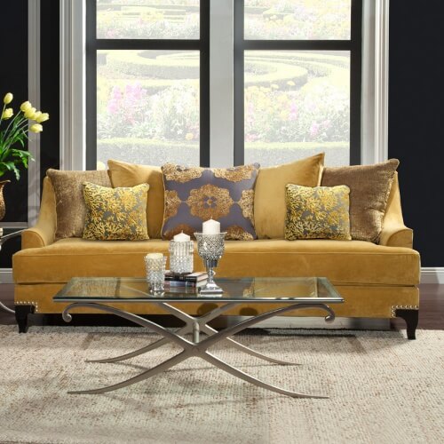This gold sofa with patterned back cushions and accent pillows is a strong nod to Hollywood Regency style. The soft premium upholstery, deep seats and multi-cushioned back ensures a comfortable lounging experience. The solid wood frame also ensures durability. A nailhead trim completes the look. This gold sofa with patterned back cushions and accent pillows is a strong nod to Hollywood Regency style. The soft premium upholstery, deep seats and multi-cushioned back ensures a comfortable lounging experience. The solid wood frame also ensures durability. A nailhead trim completes the look.