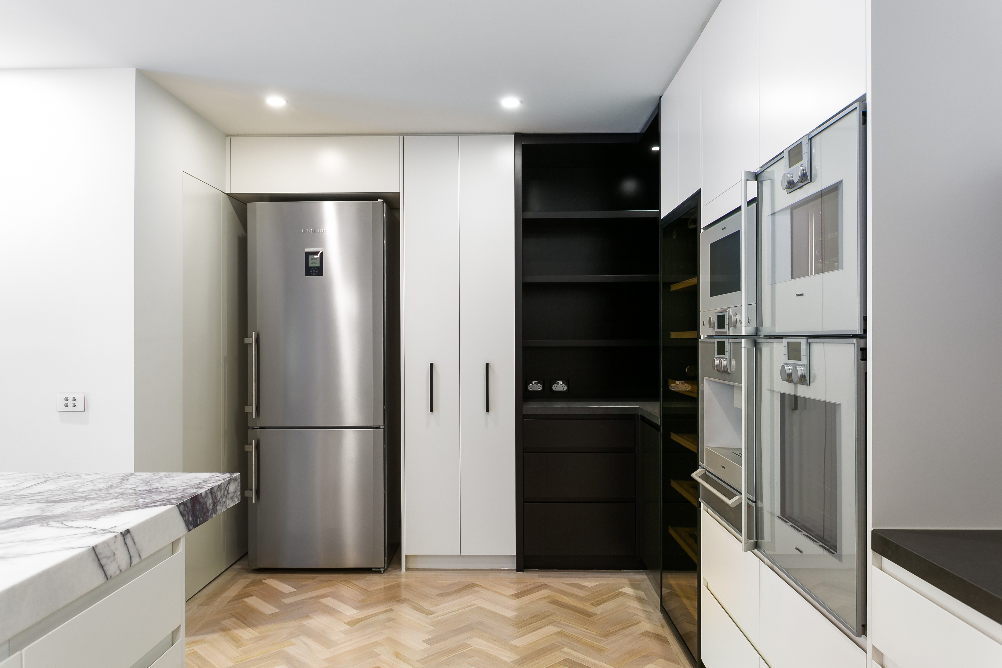 Highlighted with stainless steel appliances and dark wood corner shelving, the kitchen also hosts a full height built-in wine rack with glass door. Highlighted with stainless steel appliances and dark wood corner shelving, the kitchen also hosts a full height built-in wine rack with glass door.