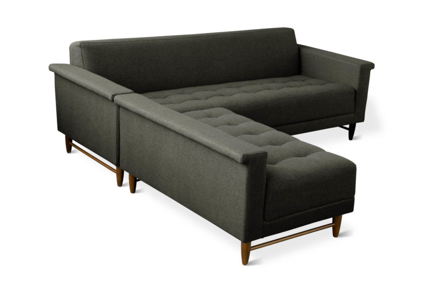 A compact, mid-century style sectional with flanged arms and tapered wooden legs. The chaise can be switched from the left to the right, or can be detached for stand alone seating. A compact, mid-century style sectional with flanged arms and tapered wooden legs. The chaise can be switched from the left to the right, or can be detached for stand alone seating.