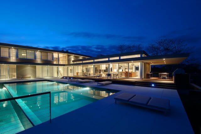 The home's pool complex is a massive, two-depth pool with tons of lounge seating for sunning. The entire length of the home has entrances to the pool area. The home's pool complex is a massive, two-depth pool with tons of lounge seating for sunning. The entire length of the home has entrances to the pool area.