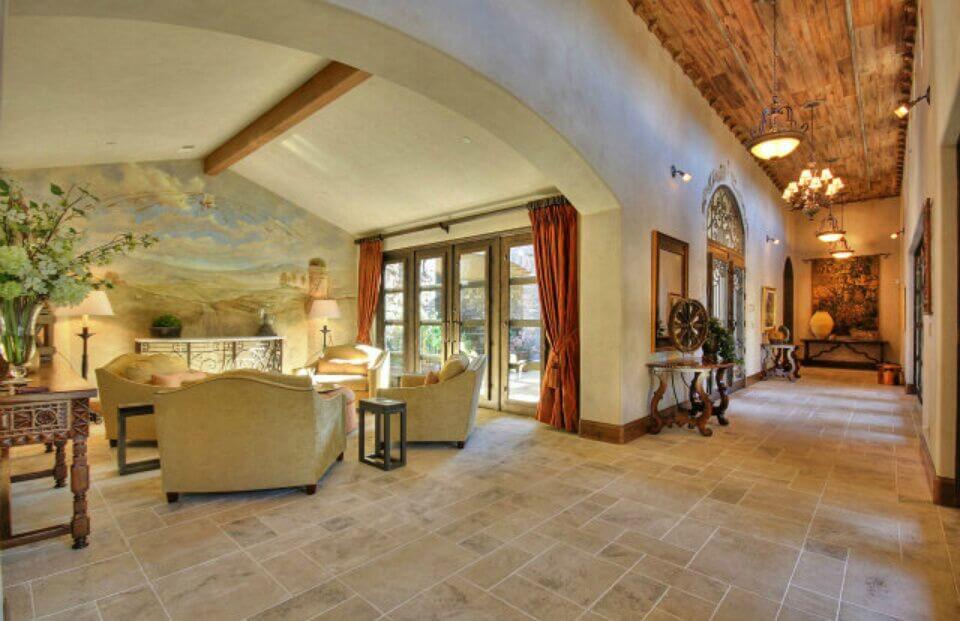 In a luxurious Tuscan-style mansion, a pastoral mural on a wall isn't an uncommon sight, but it is just as beautiful as you'd imagine. The light colors pull color out of every detail in this room.