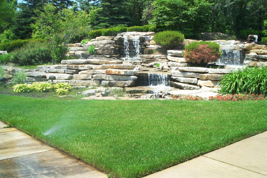 Waterfalls can make the most gorgeous addition to any yard. This waterfall uses beautiful slabs of rock for a wild looking piece. Waterfalls can make the most gorgeous addition to any yard. This waterfall uses beautiful slabs of rock for a wild looking piece.