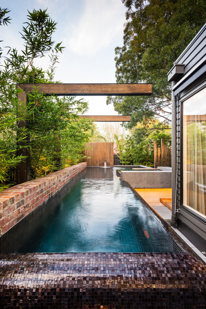The pool wraps around the home and deck structure, a lengthy, pristine water feature with wet mosaic tile edges. The pool wraps around the home and deck structure, a lengthy, pristine water feature with wet mosaic tile edges.