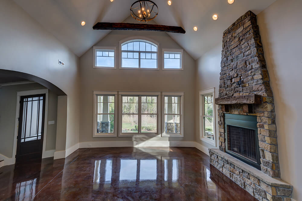 A classy home featuring sparkling tiles flooring surrounded by light gray walls and under the high vaulted ceiling.