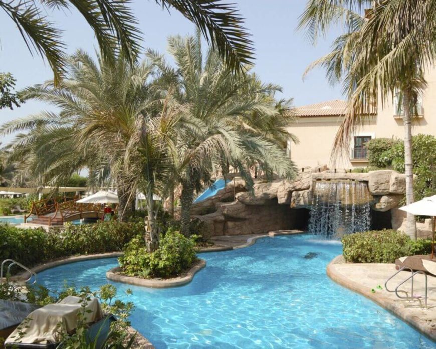 This fun backyard water park is equipped with a waterfall and a slide. This is the perfect hangout spot for a family. Invite over all your friends to beat the heat and they'll be sure to have a great time. This fun backyard water park is equipped with a waterfall and a slide. This is the perfect hangout spot for a family. Invite over all your friends to beat the heat and they'll be sure to have a great time.