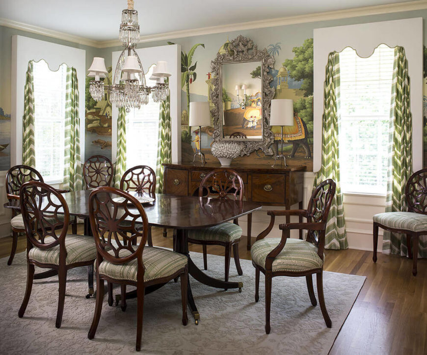 The dining room centers on an incredible rich wood dining table and matching chair set, with intricate carved backs and nailhead trim cushioning. The green and white curtains here complement the wall mural. The dining room centers on an incredible rich wood dining table and matching chair set, with intricate carved backs and nailhead trim cushioning. The green and white curtains here complement the wall mural.