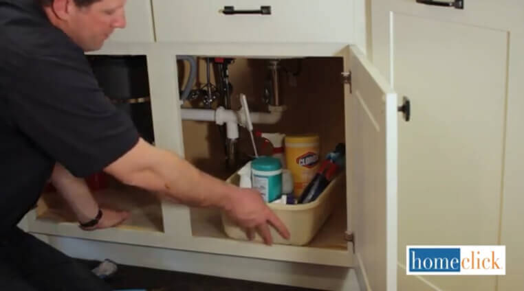 If you're anything like us, you've got a lot of stuff underneath your sink, filling the cabinets to the brim. Take everything out of there, including all the cleaners, dish rags, and assorted sundry that builds up, and set it aside. You'll need room to work in. If you're anything like us, you've got a lot of stuff underneath your sink, filling the cabinets to the brim. Take everything out of there, including all the cleaners, dish rags, and assorted sundry that builds up, and set it aside. You'll need room to work in.