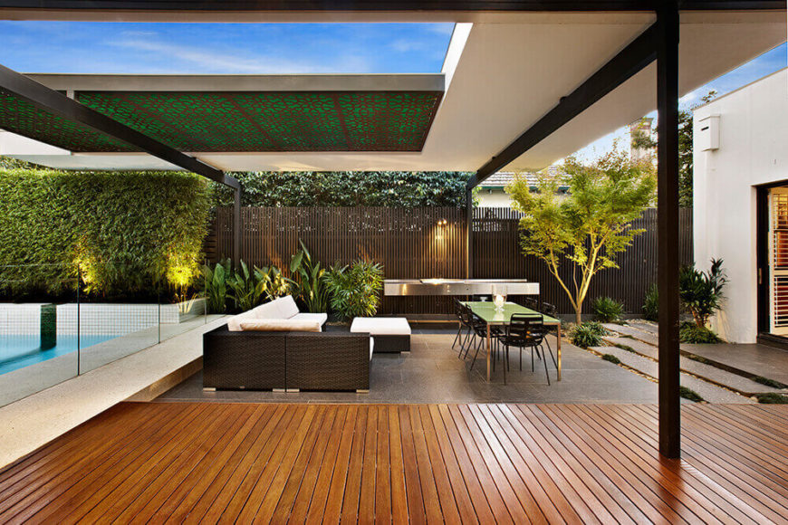 Here we see the carefully balanced interplay of elements, as white house structure meets black metal support beams above the rich hardwood and granite flooring. The sleek fence is supplemented by greenery. Here we see the carefully balanced interplay of elements, as white house structure meets black metal support beams above the rich hardwood and granite flooring. The sleek fence is supplemented by greenery.