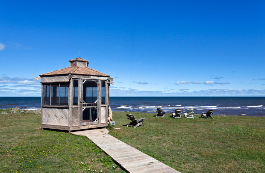 This gazebo at the end of a wooden path has permanently installed screen walls and a swinging screen door. This makes the screens on this gazebo sturdy. You won't have to worry about bugs getting in through gaps or flaps in the screen. This gazebo at the end of a wooden path has permanently installed screen walls and a swinging screen door. This makes the screens on this gazebo sturdy. You won't have to worry about bugs getting in through gaps or flaps in the screen.