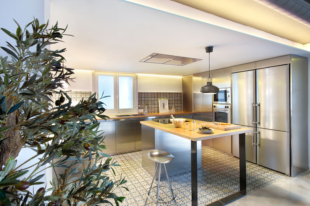 This is the stainless steel kitchen with steel kitchen counter bottom support and wooden top, steel cabinet doors, and high rise stool. This is the stainless steel kitchen with steel kitchen counter bottom support and wooden top, steel cabinet doors, and high rise stool.