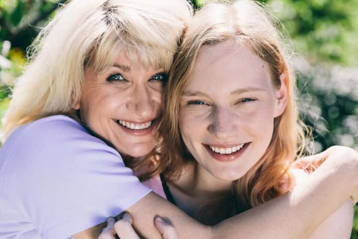 Older woman hugging young woman