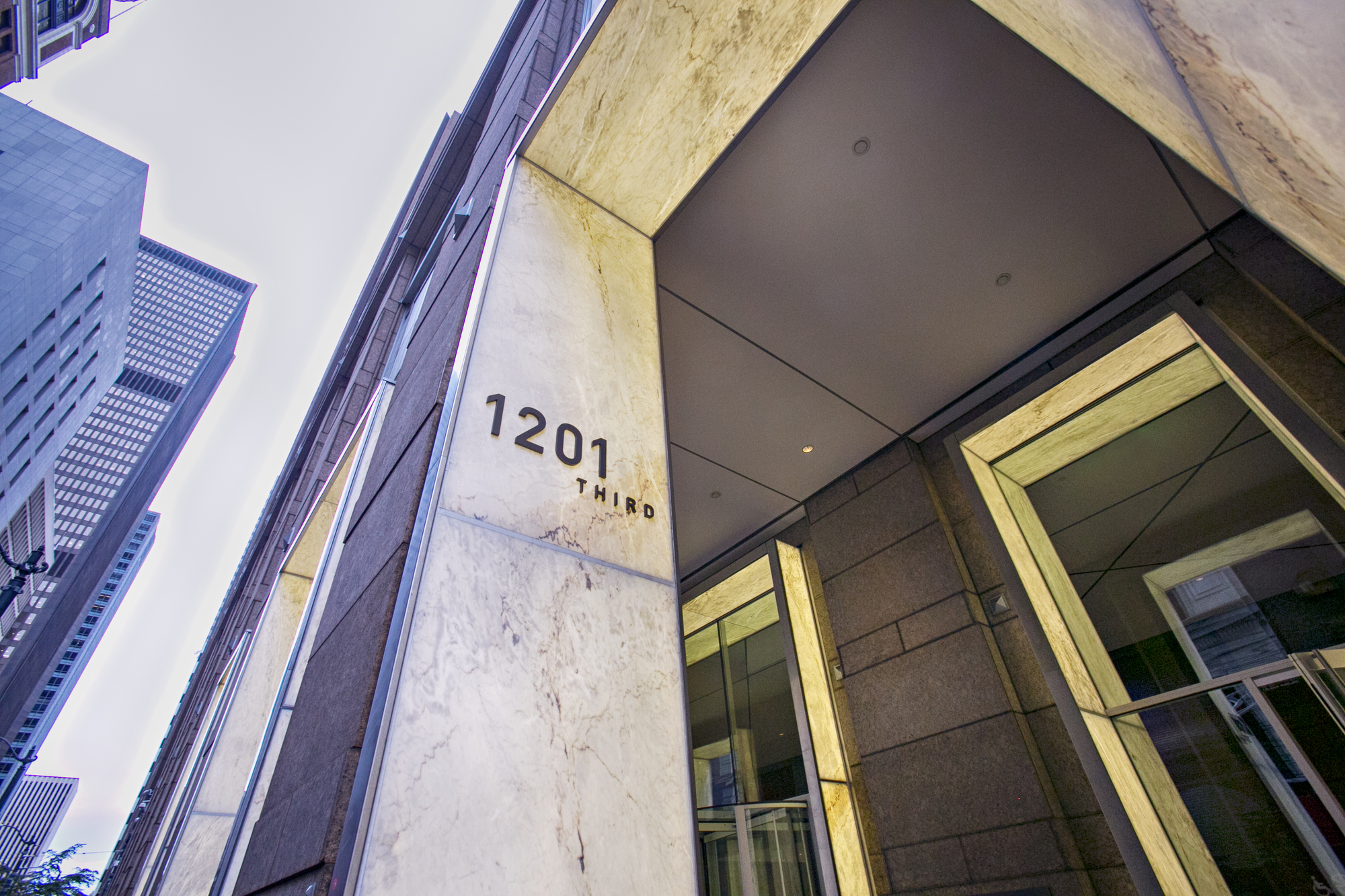 photo shot from below of an entrance to a downtown seattle office building
