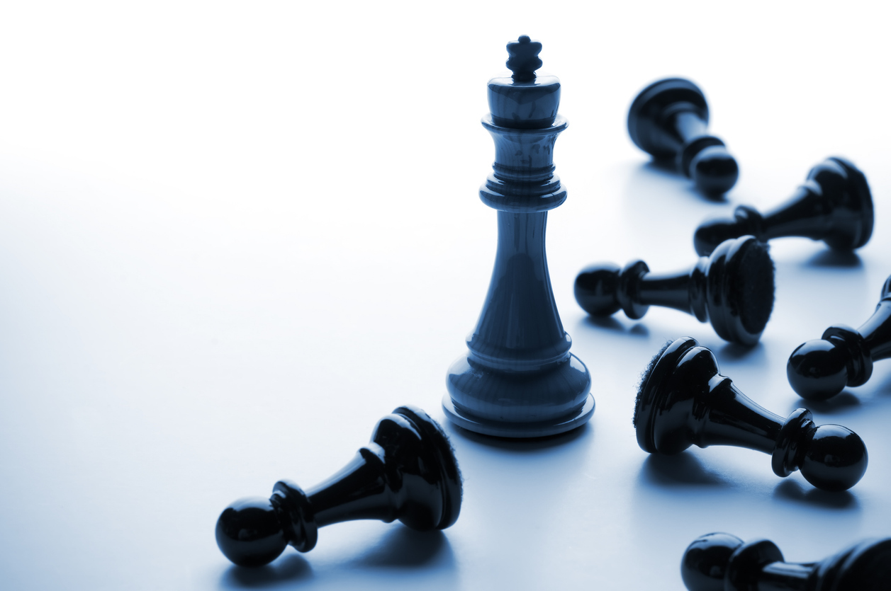 Chess king towering over pawns