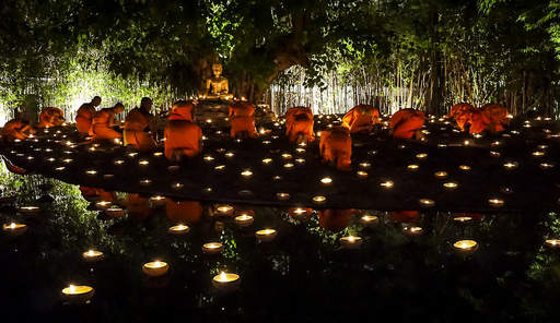 A Buddhist merit-making ceremony at Wat Phan Tao in Thailand on Visakha Bucha Day 2014. Merit-making activities are believed to have positive impacts on participants' reincarnation outcomes. Photo by John Shedrick. CC by 2.0 via Flickr. A Buddhist merit-making ceremony at Wat Phan Tao in Thailand on Visakha Bucha Day 2014. Merit-making activities are believed to have positive impacts on participants’ reincarnation outcomes. Photo by John Shedrick. CC by 2.0 via Flickr.