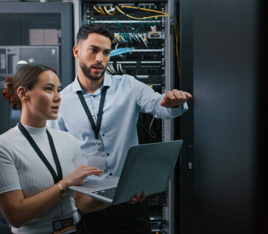 Shot of two colleagues working together in a server room