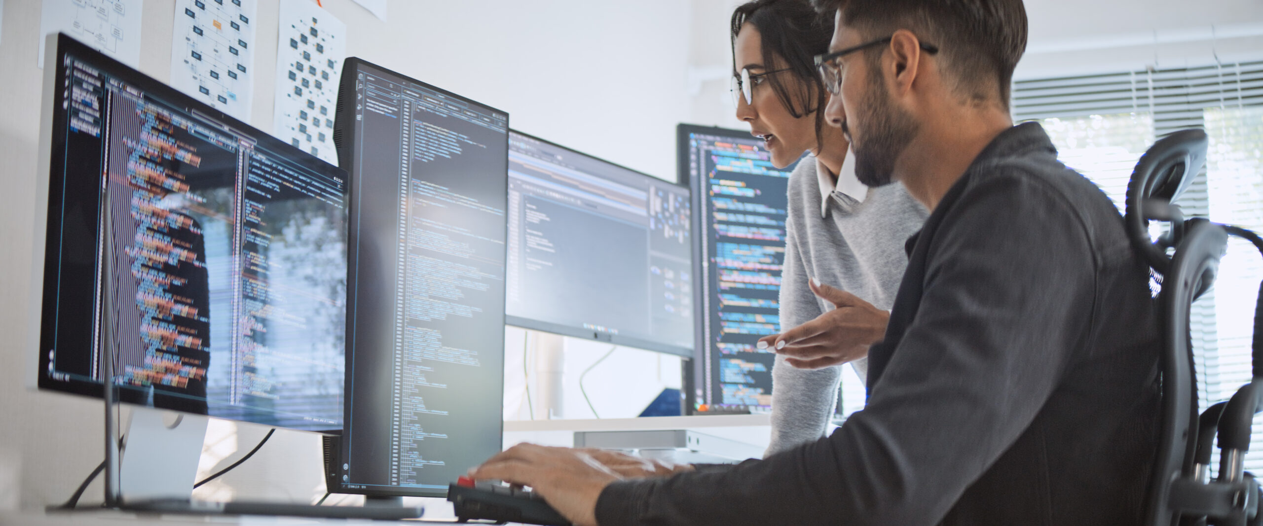 Hispanic Latin American couple, software engineer developer use computer, work on program coding together at home office. Programming language development technology, freelance job concept