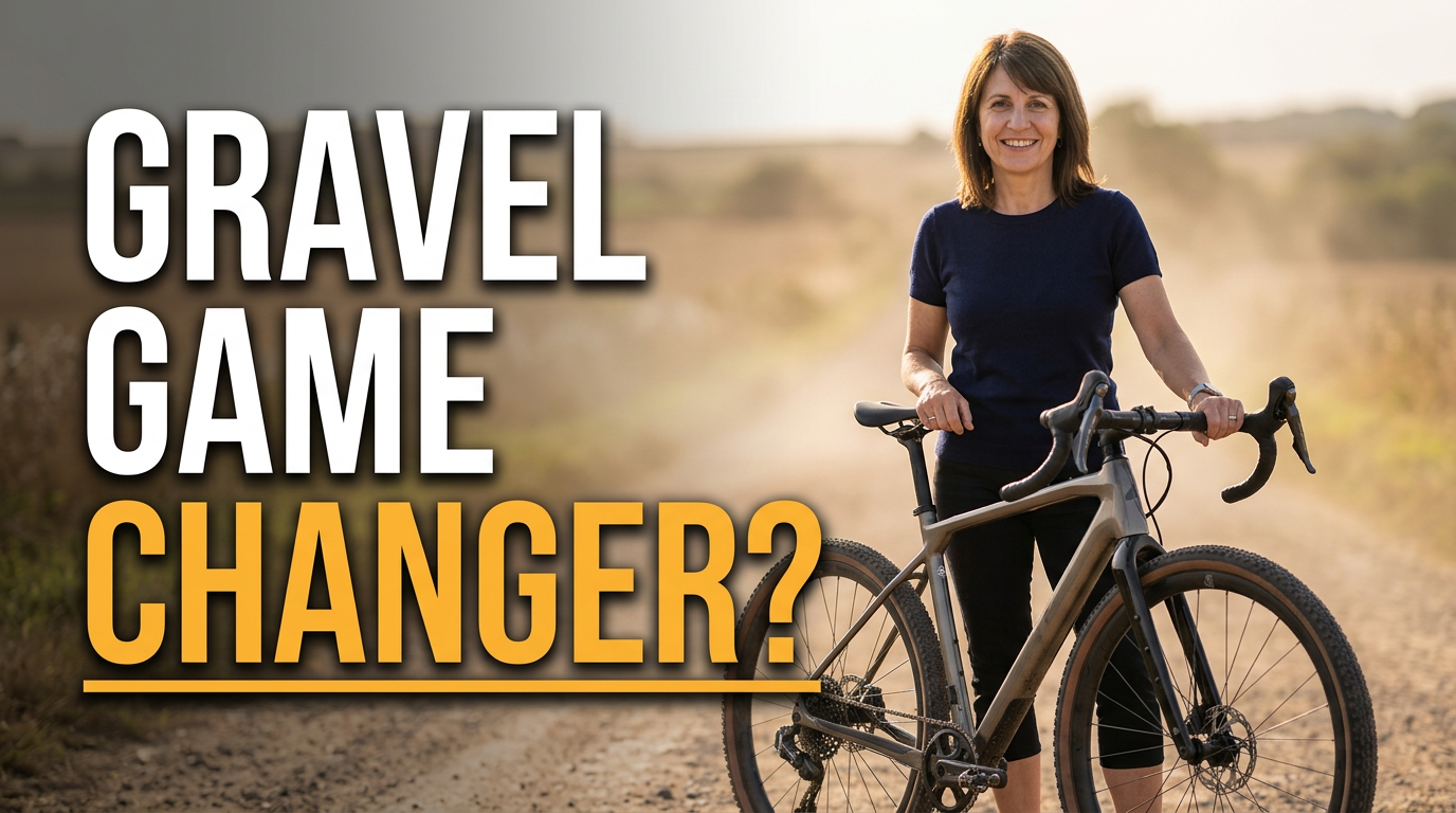 Female cyclist standing beside a gravel bike on a dusty countryside track