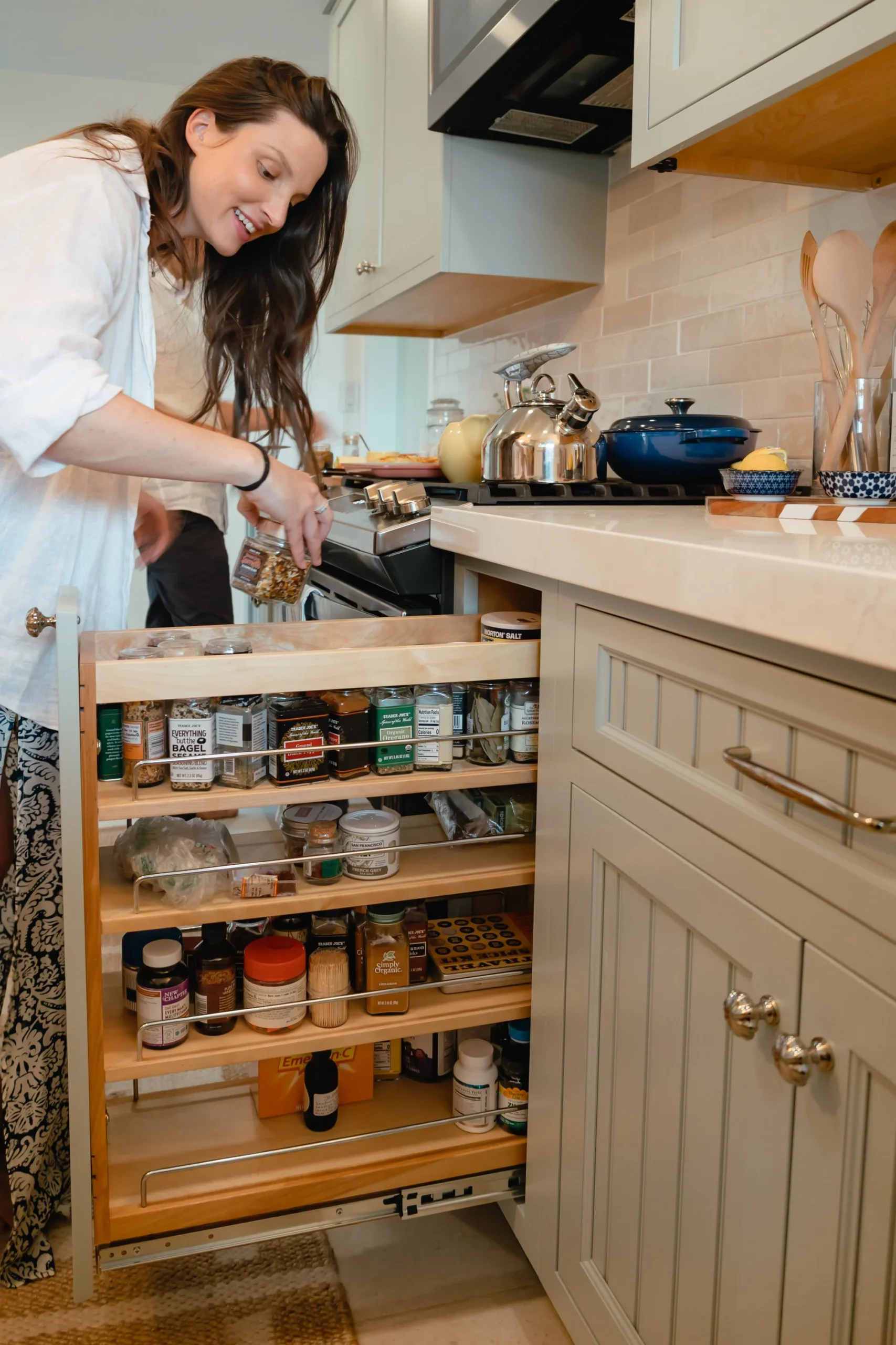 woman looking through pull out spice rack