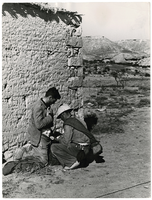 [Republican soldier having his wounded stomach wrapped at the first aid station, Rio Segre, Aragón Front, near Fraga, Spain]