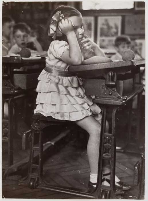 [Girl at a school desk, England]