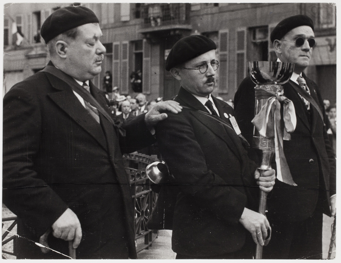 [Three veterans carry torch at peace rally, Verdun, France]