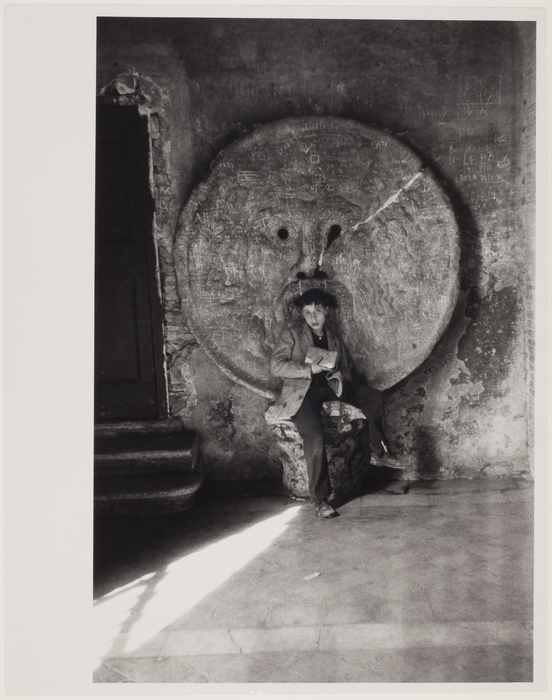 [Child in front of round statue, Rome]