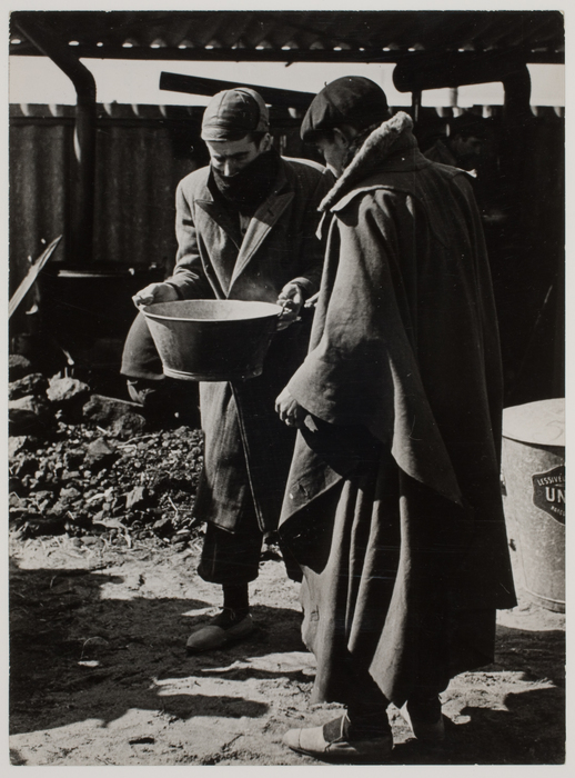 [Two men prepare food at a concentration camp for Spanish refugees, Le Barcarès, France]