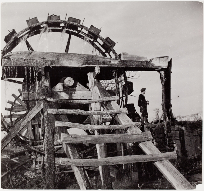 [Men standing by water wheels, Ankara, Turkey]