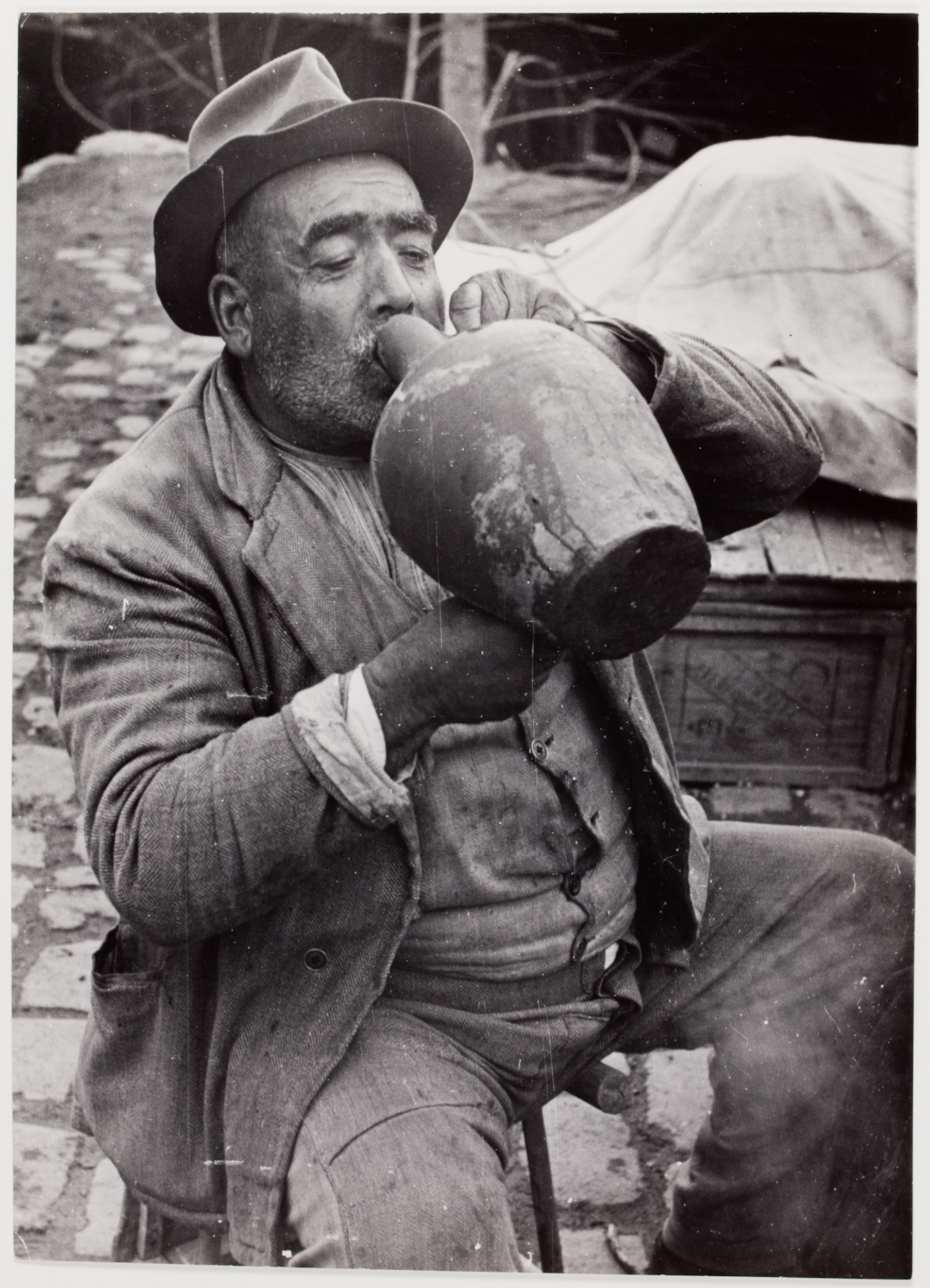 [Man drinking from a jug at a bazaar, Istanbul, Turkey] International