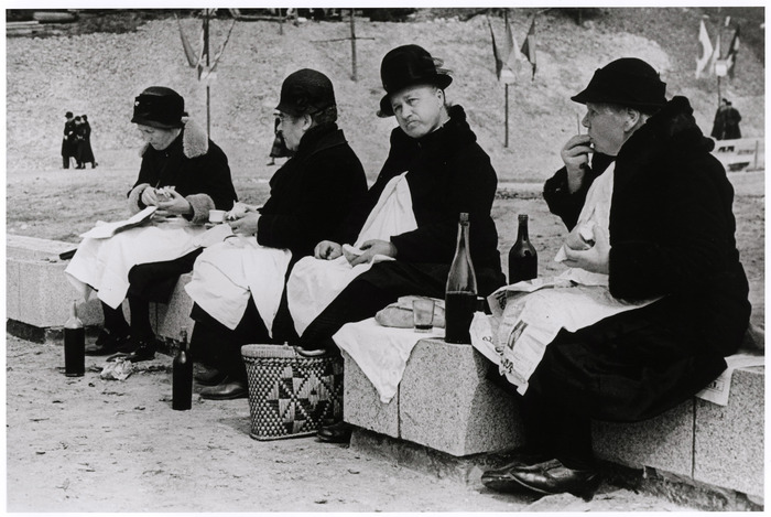 [Women eating and drinking on a stone bench, Lisieux, France]