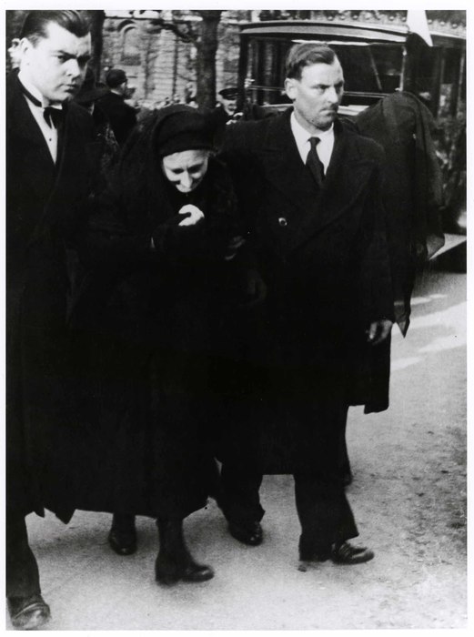 [At the funeral for several workers who had been killed in an incident of labor unrest, the arrival of the family of one of the workmen, Clichy, France]