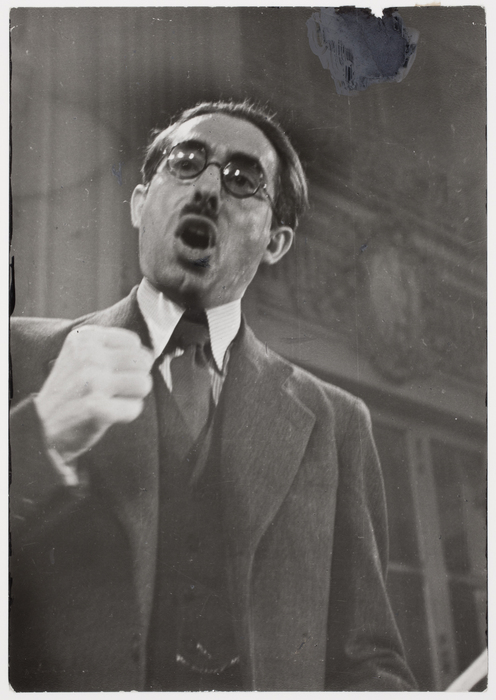 [Dark haired man with glasses and a moustache giving a speech, Paris]