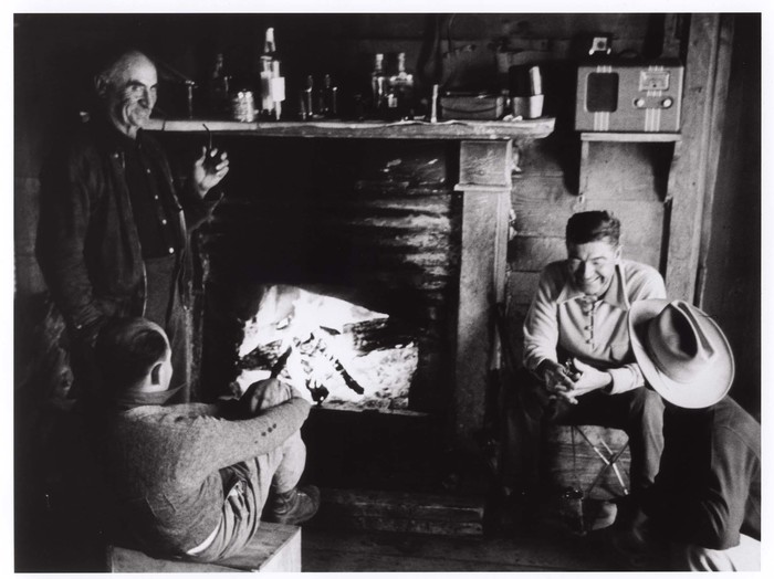 [Four men gathered around a fireplace, New Mexico ]