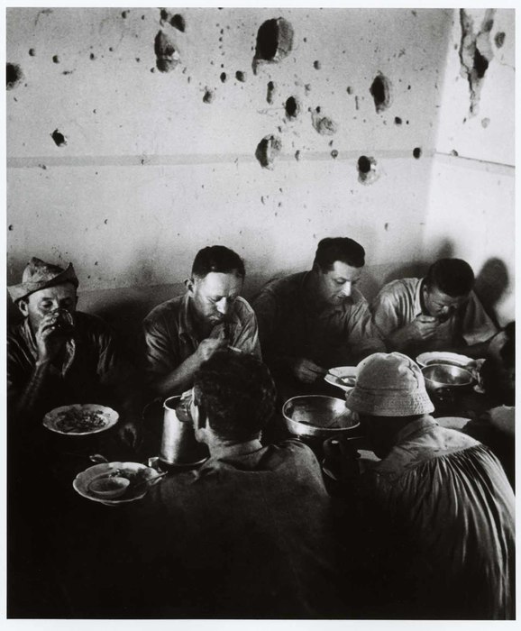 [Pock-marked walls from the fighting that Capa had covered there the previous year, during the war against the Arabs to guarantee Israel's independence, Negba kibbutz (in the northern Negev Desert)]