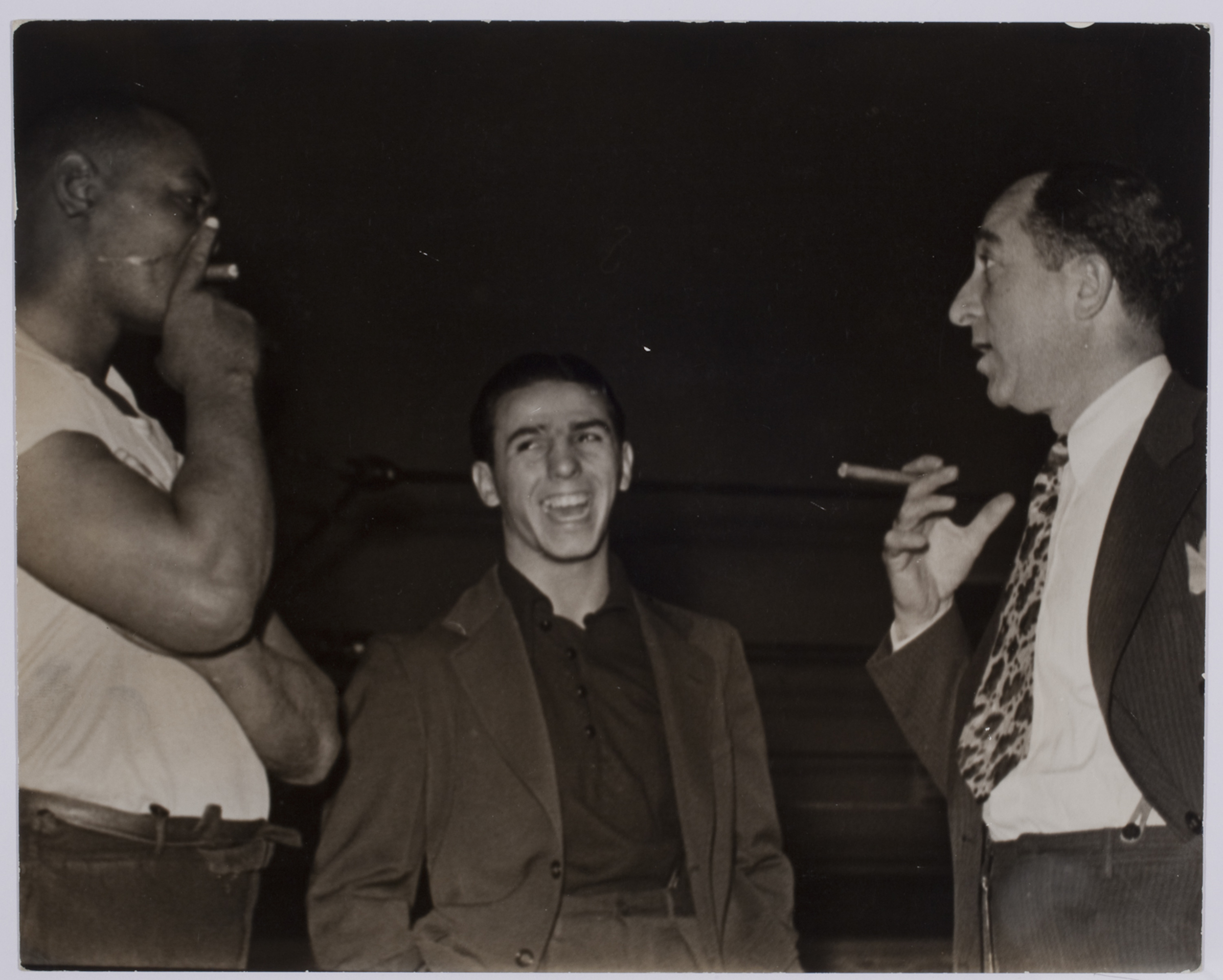 [Boxers and trainers smoking cigars at Stillman's Gym, New York