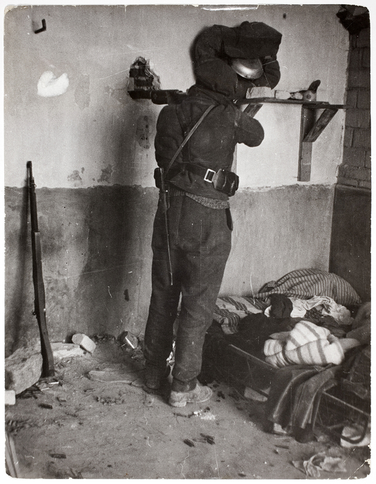 [Republican soldier aiming rifle through peephole, University City, Madrid]