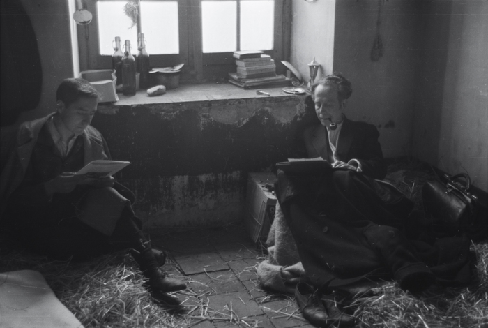 [Men reading on straw beds at an internment camp for Spanish refugees, Montolieu, France]
