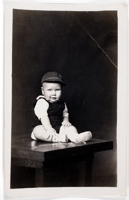 [Unidentified baby boy seated on table]