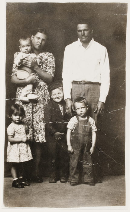 [Woman and man with four small children]