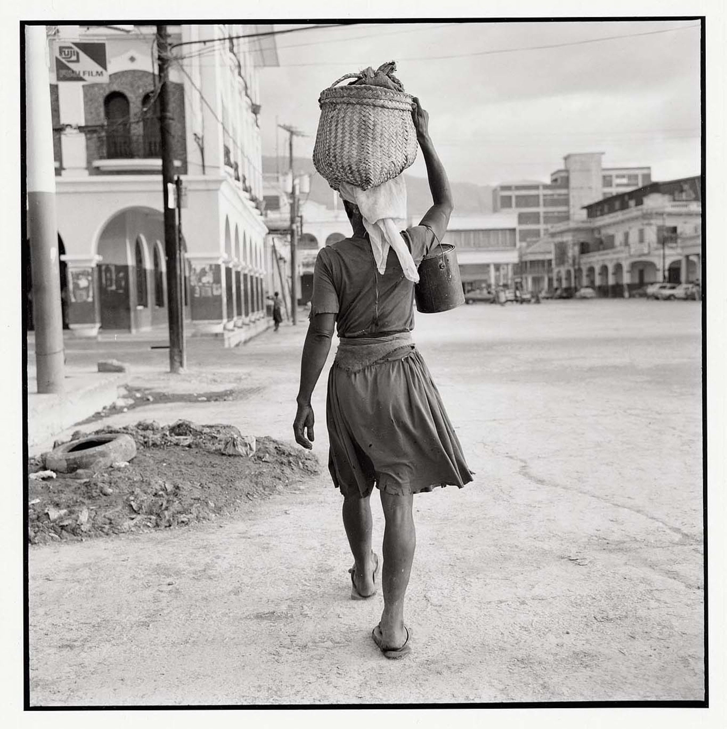 [Woman carrying basket on head, bucket on arm, Haiti] International