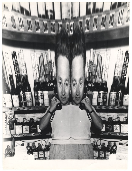 [Man in liquor store holding telephone distortion]