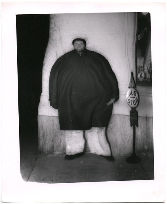 Man standing outside against wall (distortion)